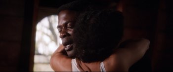Movie still from “Ragtime” (1981), directed by Milos Forman – A person hugging another person; Close Up shot, Low angle