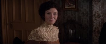 Movie still from “Ragtime” (1981), directed by Milos Forman – A person wearing a dress; Close Up shot, Over the shoulder angle