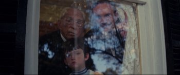 Movie still from “Ragtime” (1981), directed by Milos Forman – An older man and a young boy are reflected in a mirror; Close Up shot, Over the shoulder angle