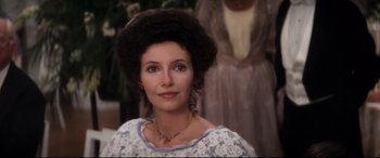 Movie still from “Ragtime” (1981), directed by Milos Forman – A person wearing a dress; Close Up shot, Over the shoulder angle