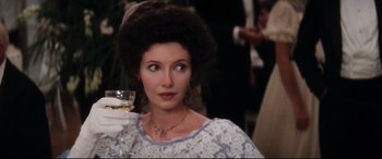 Movie still from “Ragtime” (1981), directed by Milos Forman – A person holding a wine glass; Close Up shot, Over the shoulder angle