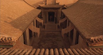 Movie still from “Raise the Red Lantern” (1991), directed by Yimou Zhang – An aerial view of a courtyard with a statue of a person; Extreme Wide shot, High angle