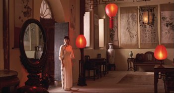 Movie still from “Raise the Red Lantern” (1991), directed by Yimou Zhang – A woman standing in a room with red lanterns; Wide shot, Low angle