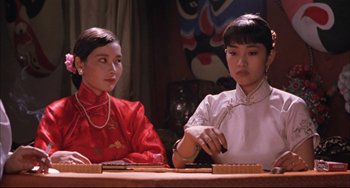 Movie still from “Raise the Red Lantern” (1991), directed by Yimou Zhang – Two women sitting at a table in front of a painting; Close Up shot, Low angle