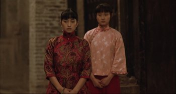 Movie still from “Raise the Red Lantern” (1991), directed by Yimou Zhang – Two young asian women standing next to each other; Medium shot, Low angle
