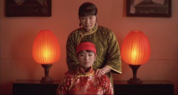Movie still from “Raise the Red Lantern” (1991), directed by Yimou Zhang – An older woman and a younger woman wearing oriental clothing; Medium shot, Low angle