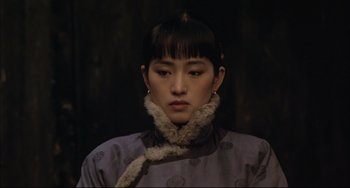 Movie still from “Raise the Red Lantern” (1991), directed by Yimou Zhang – A young woman wearing a purple dress and a fur collar; Close Up shot, Over the shoulder angle