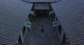 Movie still from “Raise the Red Lantern” (1991), directed by Yimou Zhang – An aerial view of a person holding a flag; Extreme Wide shot, High angle