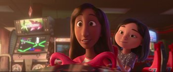 Movie still from “Ralph Breaks the Internet” (2018), directed by Rich Moore – A woman is smiling while sitting at a table with another woman; Close Up shot, Over the shoulder angle