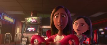 Movie still from “Ralph Breaks the Internet” (2018), directed by Rich Moore – A woman is looking at the camera in a room with other people; Close Up shot, Over the shoulder angle