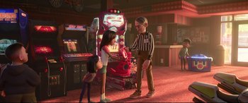 Movie still from “Ralph Breaks the Internet” (2018), directed by Rich Moore – Two girls and a boy playing a video game in a room; Wide shot, Over the shoulder angle
