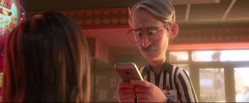 Movie still from “Ralph Breaks the Internet” (2018), directed by Rich Moore – An old man is looking at his phone; Close Up shot, Over the shoulder angle