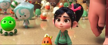 A girl is standing next to a candy corn