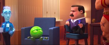 Movie still from “Ralph Breaks the Internet” (2018), directed by Rich Moore – An animated character sitting in a chair next to a man; Wide shot, Over the shoulder angle