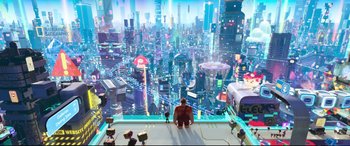 Movie still from “Ralph Breaks the Internet” (2018), directed by Rich Moore – An image of an animated city scene with a person standing in front of it; Extreme Wide shot, High angle
