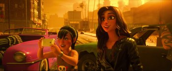 Movie still from “Ralph Breaks the Internet” (2018), directed by Rich Moore – Two women are standing next to each other in front of a car; Close Up shot, Over the shoulder angle