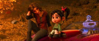 Movie still from “Ralph Breaks the Internet” (2018), directed by Rich Moore – A woman sitting on top of a car next to a small girl; Medium shot, High angle