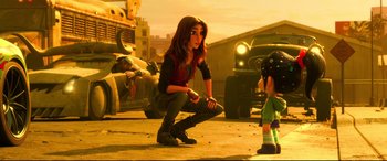 Movie still from “Ralph Breaks the Internet” (2018), directed by Rich Moore – A woman kneeling down next to another woman; Wide shot, Over the shoulder angle
