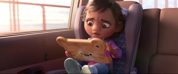 Movie still from “Ralph Breaks the Internet” (2018), directed by Rich Moore – A little girl sitting in a car seat holding a tablet computer; Close Up shot, Over the shoulder angle