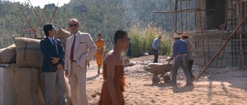 Movie still from “Rambo III” (1988), directed by Peter MacDonald – A group of people standing on top of a sandy beach; Wide shot, Over the shoulder angle