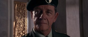 Movie still from “Rambo III” (1988), directed by Peter MacDonald – An older man in a military uniform wearing a hat; Close Up shot, Low angle