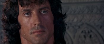 Movie still from “Rambo III” (1988), directed by Peter MacDonald – A person with long hair; Close Up shot, Low angle