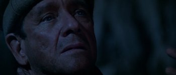 Movie still from “Rambo III” (1988), directed by Peter MacDonald – A man's face in the dark; Close Up shot, Low angle