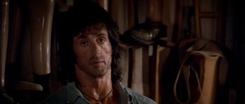 Movie still from “Rambo III” (1988), directed by Peter MacDonald – Sylvester stallone in rambo : first blood part ii; Close Up shot, Over the shoulder angle
