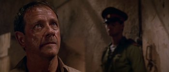 Movie still from “Rambo III” (1988), directed by Peter MacDonald – A person with a military uniform; Close Up shot, Low angle