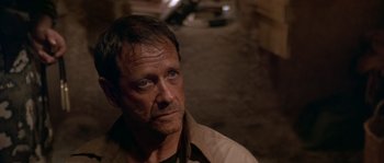 Movie still from “Rambo III” (1988), directed by Peter MacDonald – A person wearing a jacket; Close Up shot, Over the shoulder angle