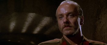 Movie still from “Rambo III” (1988), directed by Peter MacDonald – An older man with a mustache and a beard; Close Up shot, Low angle