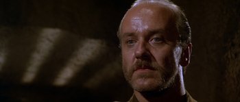 Movie still from “Rambo III” (1988), directed by Peter MacDonald – An older man with a beard and a mustache; Close Up shot, Low angle