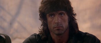 Movie still from “Rambo III” (1988), directed by Peter MacDonald – A person with long hair; Close Up shot, Low angle
