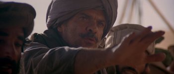 Movie still from “Rambo III” (1988), directed by Peter MacDonald – A person wearing a turban; Close Up shot, Over the shoulder angle