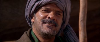 Movie still from “Rambo III” (1988), directed by Peter MacDonald – A person wearing a turban; Close Up shot, Over the shoulder angle