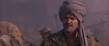Movie still from “Rambo III” (1988), directed by Peter MacDonald – A person with a turban on; Close Up shot, Over the shoulder angle
