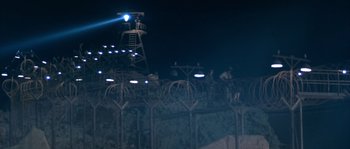 Movie still from “Rambo III” (1988), directed by Peter MacDonald – A view of a night sky with a tower in the background; Extreme Wide shot, High angle
