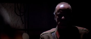 Movie still from “Rambo III” (1988), directed by Peter MacDonald – A person wearing a military uniform; Close Up shot, Low angle