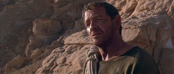 Movie still from “Rambo III” (1988), directed by Peter MacDonald – A person with a rope on his neck; Close Up shot, Low angle