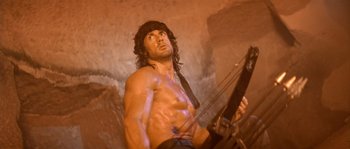Movie still from “Rambo III” (1988), directed by Peter MacDonald – A statue of a man holding a bow and arrow; Medium shot, Low angle