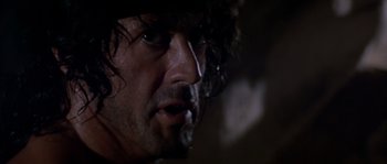 Movie still from “Rambo III” (1988), directed by Peter MacDonald – A man's face in the dark; Close Up shot, Low angle