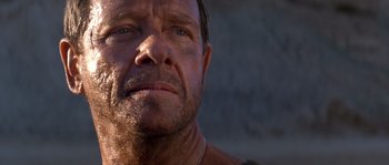 Movie still from “Rambo III” (1988), directed by Peter MacDonald – A man's face in the sunlight; Close Up shot, Low angle