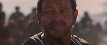 Movie still from “Rambo III” (1988), directed by Peter MacDonald – A person with a scar on his face; Close Up shot, Over the shoulder angle