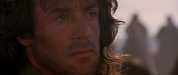 Movie still from “Rambo III” (1988), directed by Peter MacDonald – A person with long hair; Close Up shot, Low angle