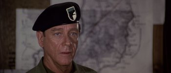 Movie still from “Rambo: First Blood Part II” (1985), directed by George P. Cosmatos – A person wearing a hat; Close Up shot, Over the shoulder angle