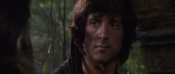 Movie still from “Rambo: First Blood Part II” (1985), directed by George P. Cosmatos – A person with wet hair; Close Up shot, Over the shoulder angle