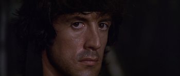 Movie still from “Rambo: First Blood Part II” (1985), directed by George P. Cosmatos – A person's face with water on their face; Close Up shot, Low angle