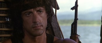 Movie still from “Rambo: First Blood Part II” (1985), directed by George P. Cosmatos – Sylvester stallone's face in rambo : first blood part ii; Close Up shot, Over the shoulder angle
