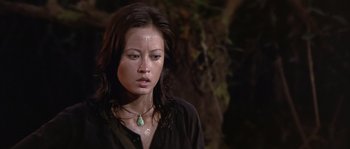 Movie still from “Rambo: First Blood Part II” (1985), directed by George P. Cosmatos – A woman in a black shirt is looking at the camera; Close Up shot, High angle