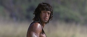 Movie still from “Rambo: First Blood Part II” (1985), directed by George P. Cosmatos – A person with wet hair; Close Up shot, Low angle